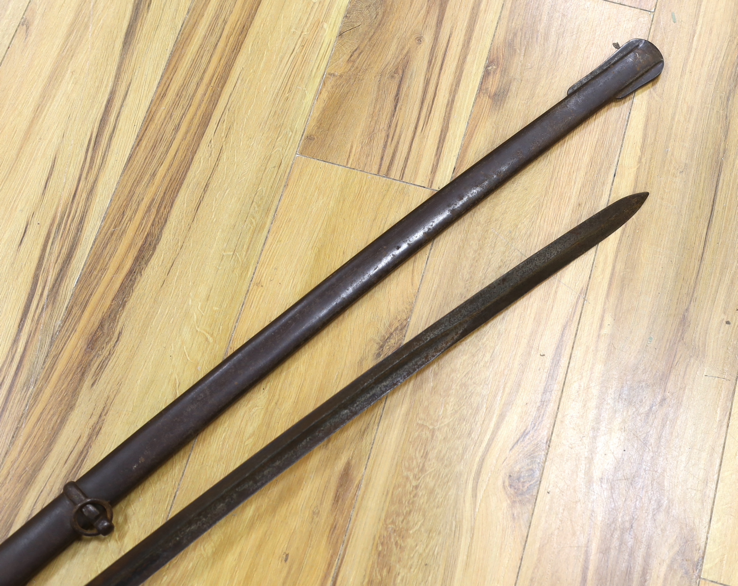 A pair of late 19th century German swords, one in its scabbard, together with another unrelated scabbard, made for the international arms trade, probably in Solingen, blade 89cm. Condition - fair, scabbards are 87cm and